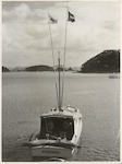 Title
Deep Sea Fishing - Bay of Islands

Publicity Caption
Bearing the flags of a Striped Marlin and the rarer Black Marlin, the launch "Rosemary" carefully manoeuvres into the wharf at Otehei Fishing Lodge. The proud fisherman is Albert C. Glassell Jnr., of Texas, U.S.A. who has reason to be well content with this fine catch, obtained with the able assistance of launchowner George Warne. 

Photographer
K.V. Bigwood