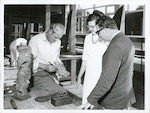 Title
Rotorua

Publicity Caption
John Taiapa, Head Carver at the Maori Arts and Crafts Institute, shows tourists intricate designs in Maori carving.

Photographer
R. Anderson.