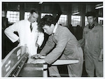 Title
Maori Apprentices

Publicity Caption
Instructor Mr. S. Patrick shows two first year panel-beating apprentices at Christchurch how to use the guillotine. From left; Mr. S. Patrick, Robert Pomare and Tama Pere.

Photographer
Mr. Anderson.