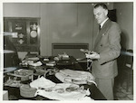 Title
Captain Cook Relics

Publicity Caption
The Queen's collection of Captain Cook relics, placed on indefinite load with the Dominion Museum, Wellington, is examined by Dr. R.A. Falla, Director of the Museum, on its arrival from the Imperial Institute, London. Comprising personal souvenirs gathered by Cook on his extensive voyaging, the collection includes a fine Maori putorino, or flute, held by Dr. Falla articles of native handiwork from British Columbia, the Pacific Islands and New Zealand, and some shells and tiny fish-hooks found in the explorer's pockets after his violent death in the Hawaiian Islands in 1779. The relics will probably be seen in other New Zealand centres after their initial display in Wellington.

Photographer
E. Woollett.