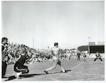 Title:
San Antonians Men's Softball team in New Zealand

Publicity Caption:
Henry 'Sugar' Garcia swings and connects. Catcher Nunns and umpire Ray Weaver have nothing to do but watch. In the background, manager Everett Burchfield shades his eyes, Jim Swilley leads off third base and New Zealand Colin Ward is tensed but not needed.

Photographer:
Mr Nicholson