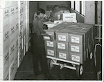 Title:
Woolston Empire Rubber Mills, Woolston, Christchurch

Publicity Caption:
John Craig (front) and K Petherom dispatching milking machine inflations. These are exported to Australia, USA and United Kingdom. Small quantities are exported to most of the dairy countries. 1/4 million annual export and hope to improve.

Photographer:
Mr Neill