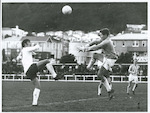 Title:
Sports - Soccer

Publicity Caption:
International Soccer England vs. New Zealand Invitation XI at Basin Reserve, Wellington on June 2nd, 1969. The score was England 7 - New Zealand 1. England centre forward, Tony Hateley 'nods' the ball over the head of the advancing New Zealand goal-keeper, Derrick Phillips to score England's final goal. Watching proceedings are England's Norman Piper (obscured) and New Zealand's G. Davis.

Photographer:
Mr. Clark