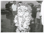 Title:
Pacific Islands - Cook Islands - Rarotonga - People

Publicity Caption:
Rarotonga.
Son of Mr A.R. Henry, showered with Frangipani 'Ei' [or 'Lei'] at Rarotonga Airport.

Photographer:
W. Cleal