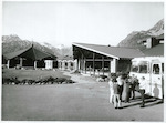 Title:
[Canterbury - Cook, Mt. [Mt. Cook]] [Or Canterbury - Hermitage, Mt. Cook]

Publicity Caption:
Mount Cook - South Island, New Zealand - a tour coach at The Hermitage Lodge showing the guests lounge in centre of picture and a new restaurant, the Panorama Room, on the left.

Photographer:
Unknown [possibly R. Anderson]