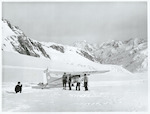 Title:
Canterbury - Tasman Glacier

Publicity Caption:
Cessna Ski Plane and Tourists on the Tasman Glacier, Mount Cook in the background, Canterbury.

Photographer:
R. Anderson