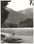 Title:
Fishing - Trout

Publicity Caption:
Peter Donaghy, a fishing guide with the Hollyford Tourist and Travel Co., landing a brown trout caught in the Hollyford River. The Bryneira Range is in the background, Fiordland National Park. Otago

Photographer:
R. Anderson