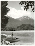 Title:
Fishing - Trout

Publicity Caption:
Peter Donaghy, a fishing guide with the Hollyford Tourist and Travel Co., preparing to fish for brown trout in the Hollyford River, The Bryneira Mountains are in the background, Fiordland National Park. Otago

Photographer:
R. Anderson