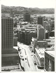 Title:
Wellington City

Publicity Caption:
Wellington. View from top of James Cook Hotel. Showing section of Lambton Quay.

Photographer:
T. Hann