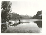 Title:
Southland - Te Anau, Lake 

Publicity Caption:
Fishing in Lake Te Anau from Entrance Island. In the background is the North Fiord with the Stuart Mts, on the left. Southland.

Photographer:
R. Anderson
