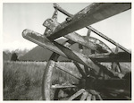 Title:
Agriculture - Machinery

Publicity Caption:
Old derelict dray on Fox Glacier flats, Mt. Tasman and Mt. Cook (at right) in background

Photographer:
M. Berthold