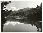 Title:
Westland - Matheson, Lake

Publicity Caption:
Lake Matheson, Mt. Tasman (at left) together with Mt. Cook (at right) mirrored in the reflections of the Lake

Photographer:
M. Berthold