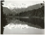 Title:
Westland - Matheson, Lake

Publicity Caption:
Lake Matheson, Mt. Tasman (at left) together with Mt. Cook (at right) mirrored in the reflections of the Lake

Photographer:
M. Berthold