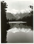 Title:
Westland - Matheson, Lake

Publicity Caption:
Lake Matheson, Mt. Tasman and Mt. Cook (at right) reflected in the mirror like waters

Photographer:
M. Berthold