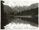 Title:
Westland - Matheson, Lake

Publicity Caption:
Lake Matheson, Mt. Tasman (at left) together with Mt. Cook (at right) mirrored in the reflections of the Lake

Photographer:
M. Berthold