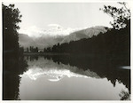 Title:
Westland - Matheson, Lake

Publicity Caption:
Lake Matheson, Mt. Tasman (at left) together with Mt. Cook (at right) mirrored in the reflections of the Lake

Photographer:
M. Berthold