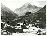 Title:
Canterbury - Cook, Mt.

Publicity Caption:
The Mt. Cook range with Mt. Cook to the left. The Hooker Valley River is in the foreground

Photographer:
T. Hann