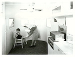 Title: Mobile Hospital  Publicity Caption: St. John Ambulance Mobile Clinic, Auckland Branch.  Young patient receives attention  Photographer: Not identified