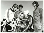 Title: 
Sports - Cycling

Publicity Caption:
Dulux Six Day Cycle Race: Noel Futter, Jean Louis Clemen, Fausto de Maria and Lou Driver examine a wheel prior to start of Dulux Six Day Cycle Race

Photographer:
Riethmaier
