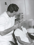 Title: 
Pacific Island - Cook Islands - Rarotonga - Health

Publicity Caption:
The Cook Islands, since 1901 a territory of New Zealand, attained internal self-government on August 4, 1965. The 20,000 inhabitants of this scattered South Pacific group, however, remain New Zealand citizens, and the former administrating country retains responsibility for the Islands' defence and External Affairs. Although Cook Islanders, in general, enjoy good dental health, this aspect of the people's welfare has not been overlooked either under the former or present administrations and a modern, well-equipped clinic has been established in the capital, Avarua, on Rarotonga, principal island of the group, here, a qualified Cook Islands Dental Officer, Mr Kaa Henry, examines the teeth of a young boy, who, like all his fellow schoolchildren, receive free dental care under the Government Health Service. 

Photographer:
Unidentified