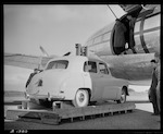 CAPTION: Rail-Air operation at Paraparaumu. Use of Curtiss C47 'Commando' Aircraft on charter from Civil Air Transport. Loading ramp attached to motor forklift with small car about to be loaded.

PHOTOGRAPHER: J.G. Duncan

DATE: 22 May 1951