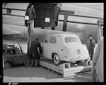 CAPTION: Rail-Air operation at Paraparaumu. Use of Curtiss C47 'Commando' Aircraft on charter from Civil Air Transport. Loading ramp attached to motor forklift with small car about to be loaded.

PHOTOGRAPHER: J.G. Duncan

DATE: 22 May 1951