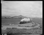 CAPTION: Inv.-Chch. Ltd. Xp. [Invercargill-Christchurch Limited Express] No 144 on curve 1 mile north of Bushey. (See Pukatapu and memorial to Sir John McKenzie in background).

PHOTOGRAPHER: J.G. Duncan

DATE: November 1951