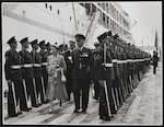 Queen Elizabeth and Guard Commander Seal lead the Duke of Edinburgh between the two rows of Royal Guards at the Inspection on Bluff Wharf, 30 January 1954