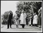 Queen Elizabeth and the Hospital dignitaries pass a row of patients as they walk the grounds of Christchurch Hospital, 19 January 1954