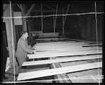 Caption: Check Appraisal officer carrying a mill study of trial gang sawing. 
Classification: 832 Conical Hill Sawmill - Sorting Table. Historical.
Photographer: J.H. Johns 
Date: 1953