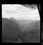 Caption: Rahu Saddle, showing main Reefton-Christchurch road. Palmers Rd. [road] left. 
Classification: 187 Beech / Nels.
Photographer: J.H. Johns
Date: 1957